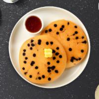 The Chocolate Pancakes · Fluffy chocolate chip pancakes cooked with care and love served with butter and maple syrup.