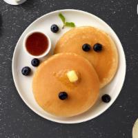 The Blueberries Pancakes · Fluffy pancakes cooked with care and love served with blueberries, butter and maple syrup.