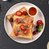 The Strawberry French Toasts · Fresh bread battered in egg, milk, and cinnamon cooked until spongy and golden brown. Topped...