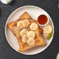 The Banana French Toasts · Fresh bread battered in egg, milk, and cinnamon cooked until spongy and golden brown. Topped...