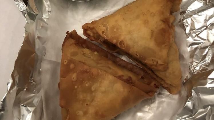 Samosa Vegetable · Crisp turnover filled with mildly spiced potatoes and potatoes and peas. Served with mint and onion chutney.