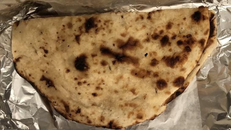 Naan · This traditional teardropped shaped white bread is baked in huge flat ovals by slapping it quickly on the sides of tandoor delicious with or without butter. Homemade Indian bread.