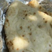 Naan Butter · Leavened bread made in clay oven from refined wheat flour.
