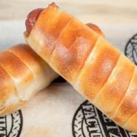 2 Hotdogs · Hotdogs hand rolled in pretzel dough, with american cheese wrapped inside.