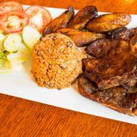 Pork Chops / Chuleta Frita · with rice and beans, plantains, and choice of salad or vegetables / con arroz y habichuelas,...