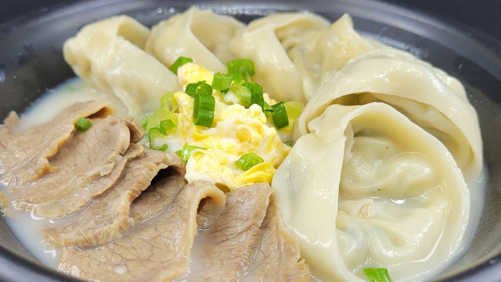 Dumpling Soup In Beef Bone Broth / 사골 만두국 · Hand made meat dumpling in beef bone broth.