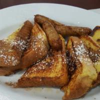 French Toast Deluxe · Includes Two Eggs, 1 Slice of Ham, 2 Strips of Bacon & 1 Sausage Link.