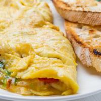 Spanish Omelet · Fluffy, buttery three egg omelet with soft, fresh mozzarella cheese, tomatoes, peppers, onio...