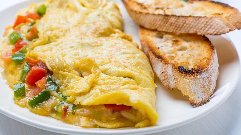 Spanish Omelet · Fluffy, buttery three egg omelet with soft, fresh mozzarella cheese, tomatoes, peppers, onions and our house marinara sauce, made to order.