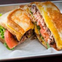 Grilled Cheese Burger · Burger patty, mayo, lettuce, tomato between two white bread grilled cheeses. Served with fries