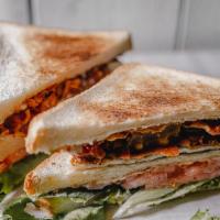 L.A.T Clubhouse  · Oven-Baked Crispy Bacon, Spring Mix, Avocado Spread, Tomato, Mozzarella Cheese and Mayo serv...