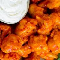 Buffalo Cauliflower · Crispy buttered cauliflower, homemade buffalo sauce. Served with ranch dressing.