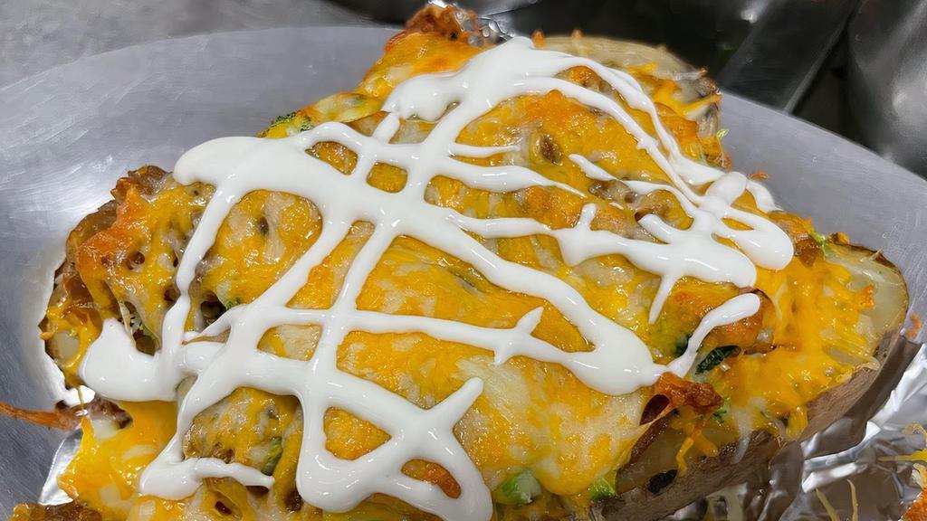 Loaded Baked Potato · Monterrey and cheddar cheese blend, bacon, beans, caramelized onions, chopped broccoli, sour cream.