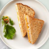 Classic Grilled Cheese · Melted American cheese served on a grilled sliced bread.