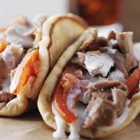 Gyro Sandwich · lamb gyro served on toasted pita bread with salad and sauce ( your choice of white sauce, ho...