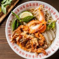 Soft Shell Crab & Shrimp Pho Noodle Soup · Grilled shrimp and soft shell crab. Served with chicken broth soup, onions, scallions, and l...