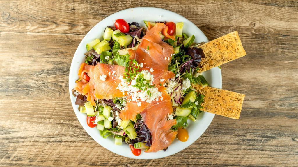 Smoked Salmon Salad · Our field greens with crumbled goat cheese, fresh chive and cucumber tossed together with our house vinaigrette and topped with norwegian smoked salmon.