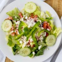 Greek Salad · Diced tomatoes, onions, cucumbers and peppers topped with feta cheese and oil and vinegar.