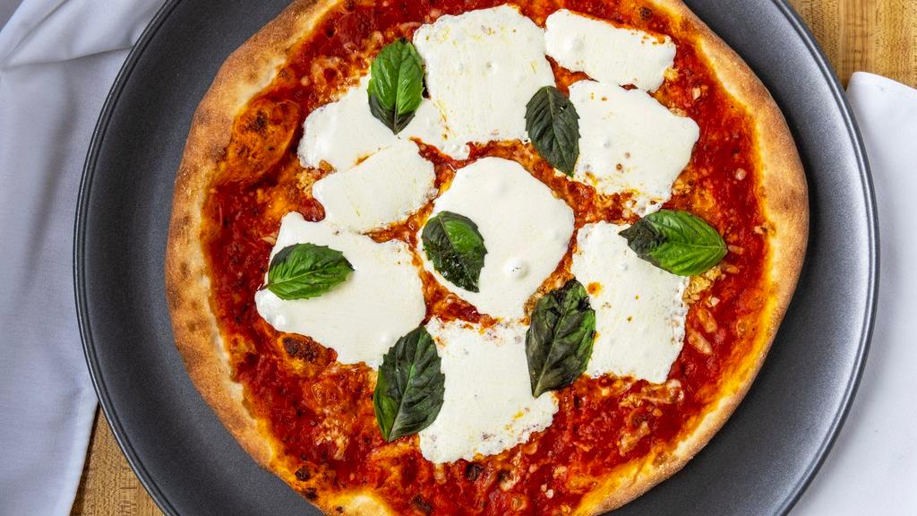 Margherita Pizza · Thin crust pizza with fresh mozzarella, marinara and fresh basil.