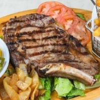 Rib Steak · 16 oz. bone in, American style rib steak grilled to your liking served with fried onions.  S...