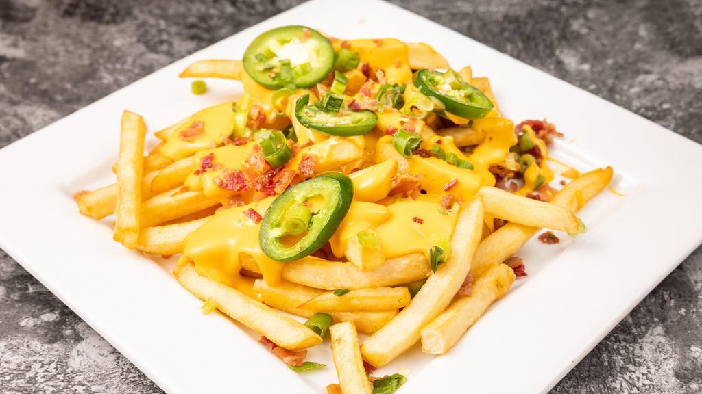 Ryan'S Loaded Fries · Topped with Monterey Jack and cheddar cheese, bacon, jalapeños and green onions.
