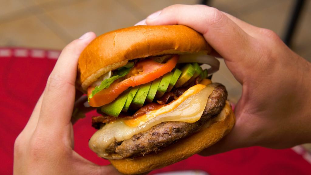 Avocado Burger · Seven oz. burger with bacon, sliced avocado, lettuce, tomato, onion, Monterey and Cheddar cheese.