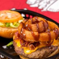 Tex-Mex Burger · Seven oz burger with Bacon, Cheddar Cheese, Onion Rings, BBQ sauce, Lettuce and Tomato!