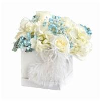 Box Of Blooms - Blue · 12” arrangement of Hydrangeas, Roses and Babies Breath in a feather adorned White box.