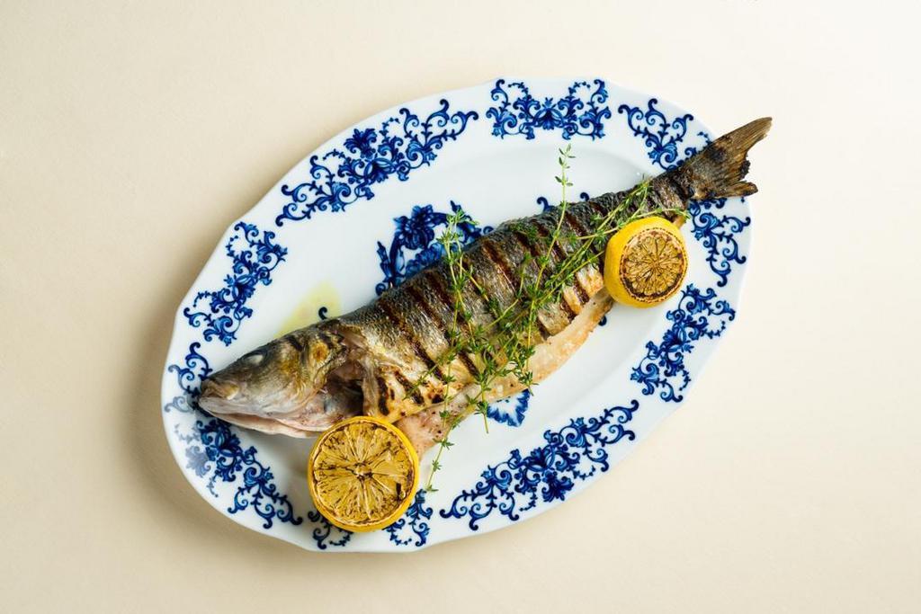 Branzino · grilled sea bass caught in the Mediterranean Sea, served with sautéed spinach