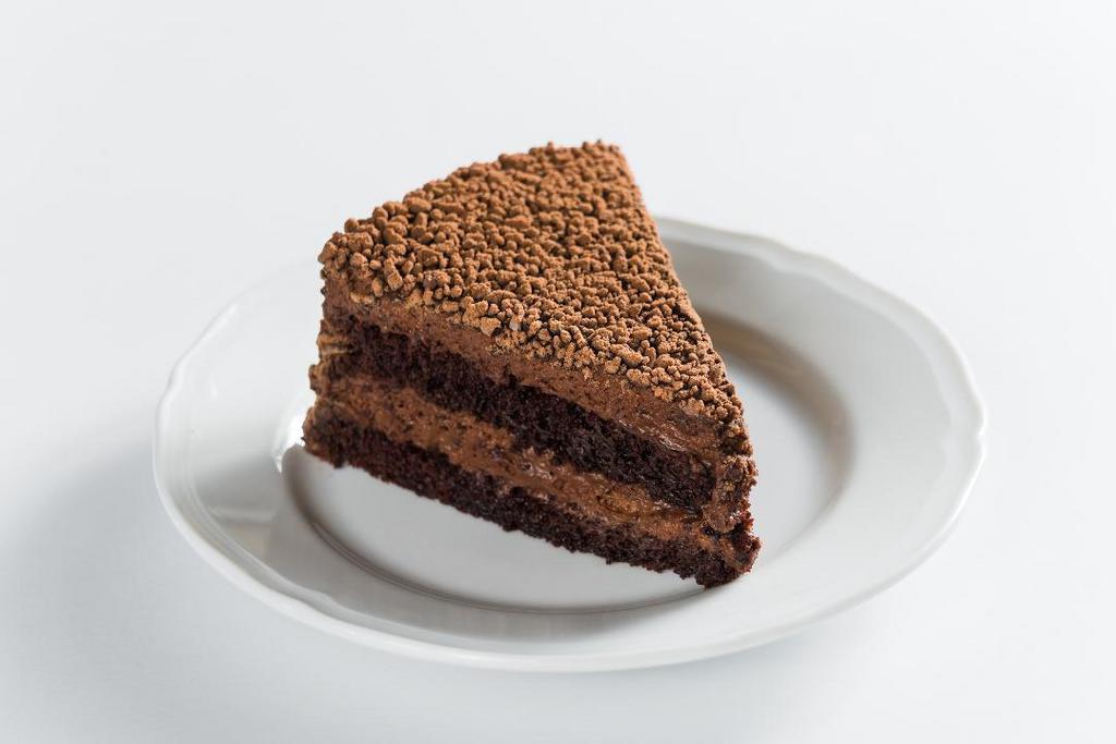 Sant Ambroeus · light chocolate mousse cake with layers of moist chocolate almond sponge, soaked with a light rum syrup, topped with chocolate granules and caramelized cocoa nibs
