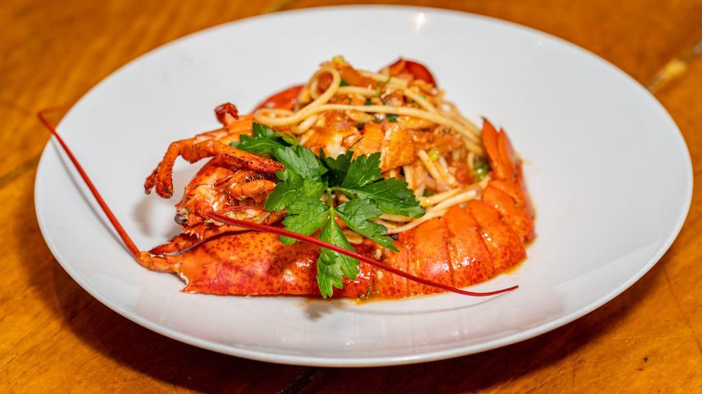 Lobster Pasta · Oven-baked lobster, Metaxa, linguini, tomatoes, fresh herbs.
