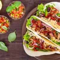 Spicy Chicken Tacos · Three street-style, soft shell tacos with tender grilled chicken with our spicy seasonings, ...