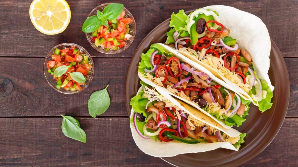 Spicy Chicken Tacos · Three street-style, soft shell tacos with tender grilled chicken with our spicy seasonings, fresh onions, radish and cilantro. Served with a lime and your choice of red or green sauce on the side.