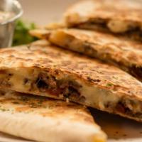 Steak Quesadilla · Marinated grilled skirt steak, grilled onions and peppers, chihuahua cheese melted in a flou...