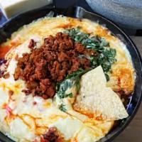 Queso Fundido · Chihuahua cheese, Spanish chorizo, roasted poblano peppers, caramelized onions, flour tortil...