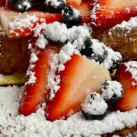 French Toast With Berries · 2 Home made French Toast with powder sugar on top and Chocolate Syrup on the side.