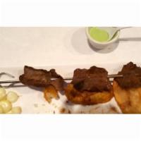 Anticuchos · Grilled beef heart made with Peruvian spices and served with half boiled and fried potato an...