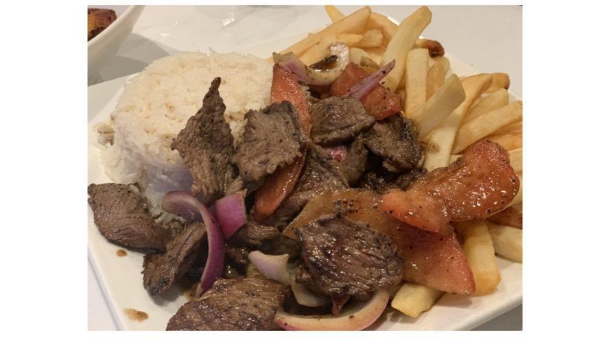 Lomo Saltado · Beef stir fried sautéed with onions, tomatoes with French fries and rice.