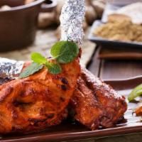 Grilled Tandoori Chicken · Exotic chicken legs marinated in lemon juice, yogurt and aromatic spices. Served half or full.