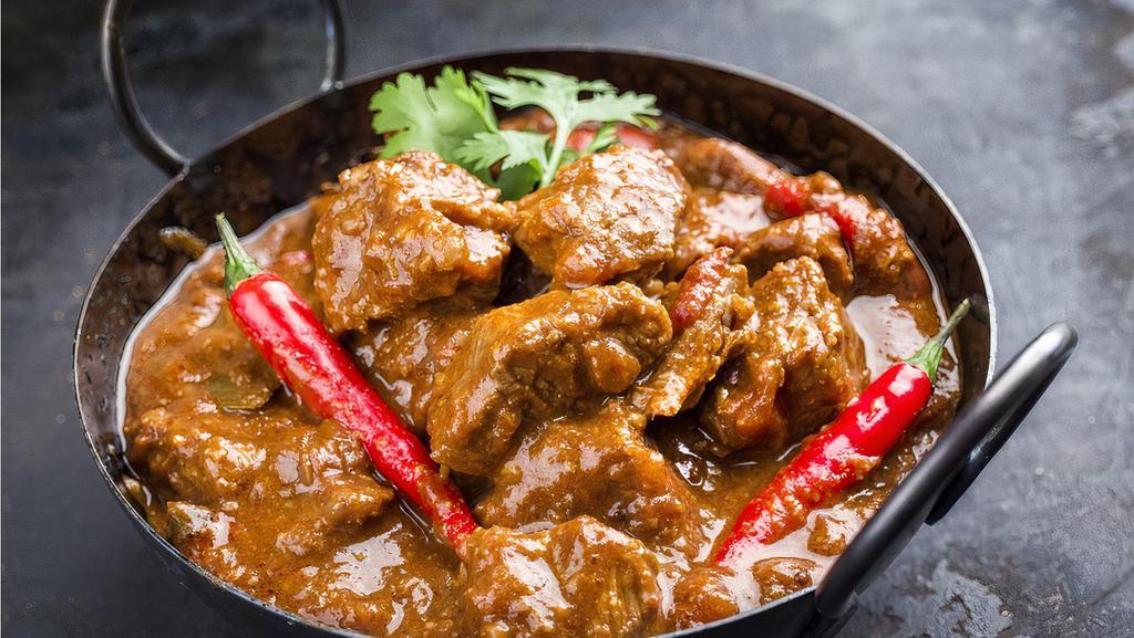 Authentic Lamb Vindaloo · Fiery marinated lamb cooked in highly flavorful spicy mixture and vinegar.