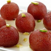 Desi Jamun · Soft fried dumplings made of thickened milk soaked in rose-flavored sugar syrup.