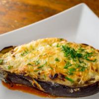 Papoutsakia · Baked stuffed eggplant with ground beef and yogurt bechamel sauce on top