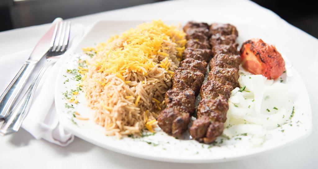 Kabab Kobideh · Char-broiled seasoned ground beef with basmati rice and grilled tomato.