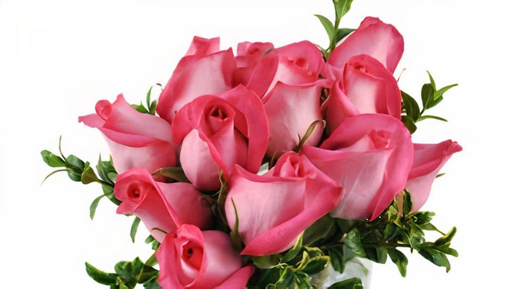 Pink Infatuation · This intoxicating arrangement is the perfect blend of sweet femininity and unabashed confidence! Our luxurious Pink Infatuation bouquet - consisting of a dozen hot pink roses - is sure to send that special someone straight to Cloud Nine!
Twelve hot-pink roses and oregonia burst from this modern arrangement in a rectangular glass vase.