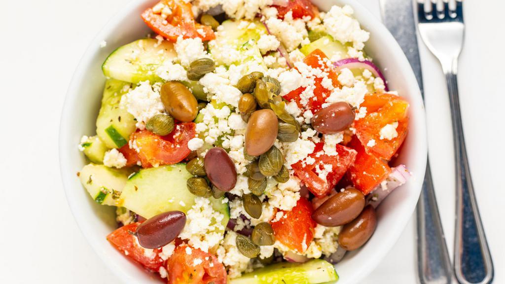 Greek Salad · Greek salad, tomatoes, onions, feta cheese, cucumbers, pepper, olives, capers, olive oil & vinegar.
