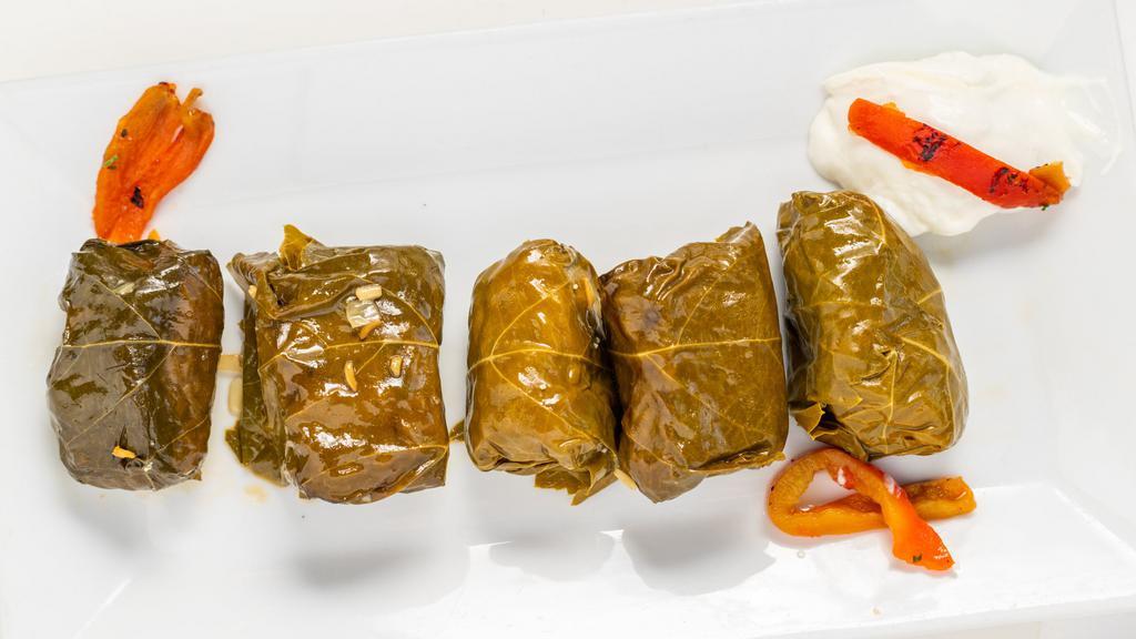 Dolmades · Stuffed grape leaves with rice & herbs.