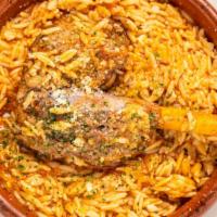 Arni Yiouvetsi · Slowly cooked lamb shank in a homemade tomato sauce over orzo, greek pasta, or Greek spaghet...