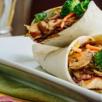 Teriyaki Wrap Sandwich · Delicious Wrap made with Marinated teriyaki chicken, grilled onions, carrots, lettuce, and t...