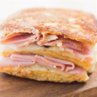 Roasted Monte Cristo Panini · Grilled Panini Sandwich made with layers of ham, smoked turkey, Swiss cheese, Cheddar cheese...