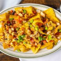 Loaded Nachos · in-house fried tortilla chips, nacho cheese, diced red & green peppers, tomato, black olives...